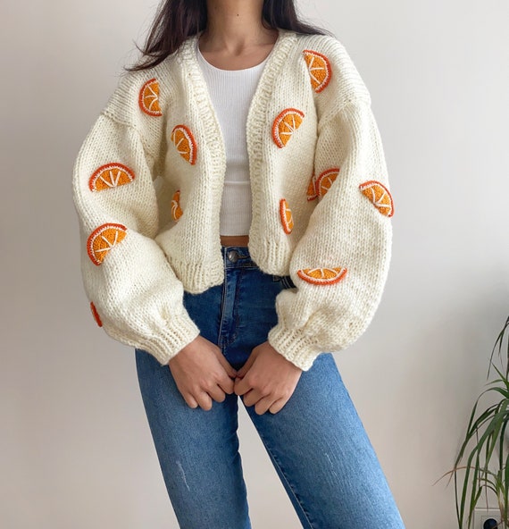 Cozy Layers: Olive Green Puffer Over Chunky Knit Sweater