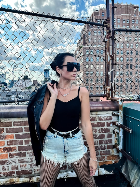 Casual Cool: Denim Shorts Paired with Bold Fishnets