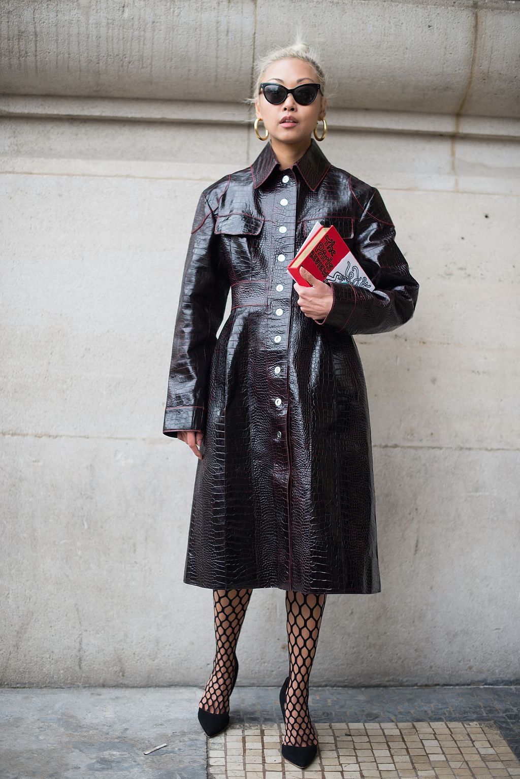 Image may contain Clothing Apparel Coat Overcoat Sunglasses Accessories Accessory Trench Coat Human and Person