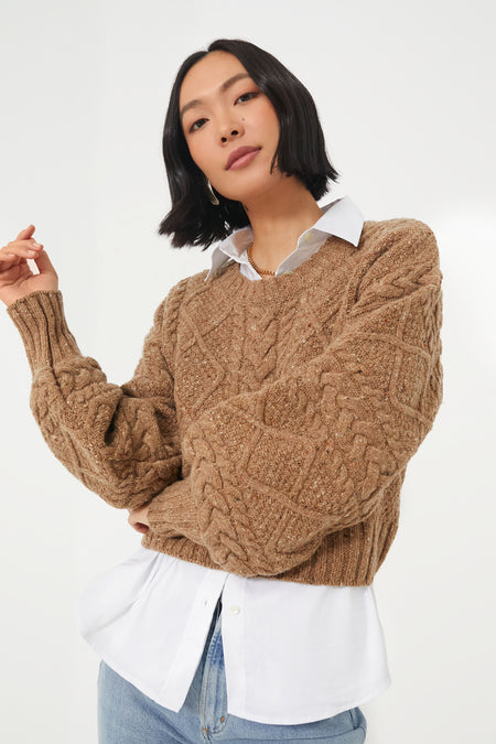 Layered Warmth: Crop Puffer over a Chunky Cable Knit Sweater