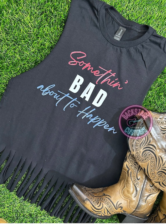 Frayed Hem Jeans Paired with a Graphic Band Tee