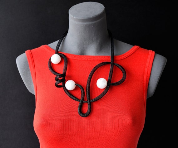 Artistic Flair: Black Shirt with Colorful Statement Jewelry