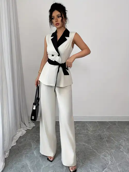 Chic Contrast: White Sleeveless Blazer Over a Black Jumpsuit