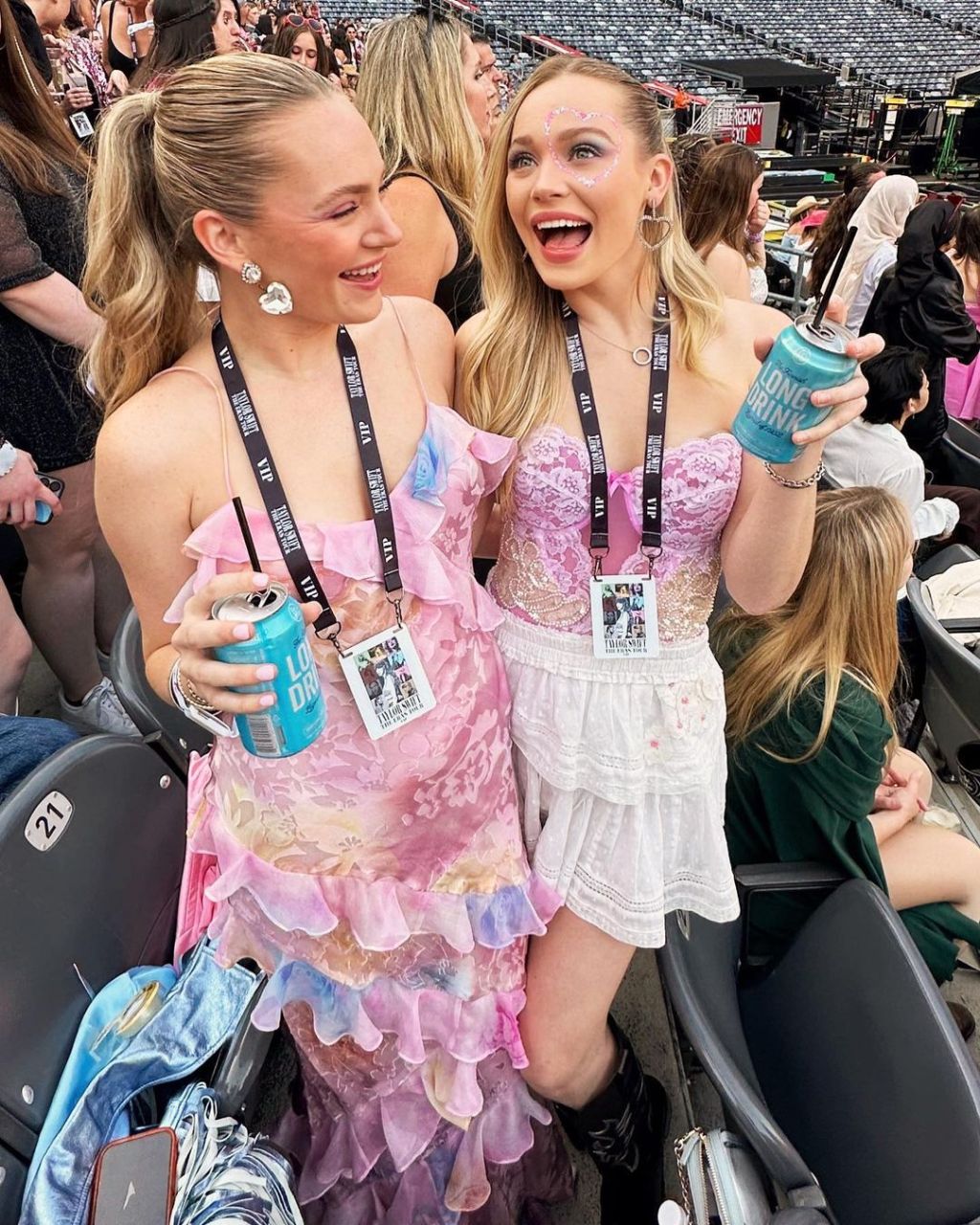 pop concert outfit idea where women are wearing Taylor Swift inspired pink floral dresses